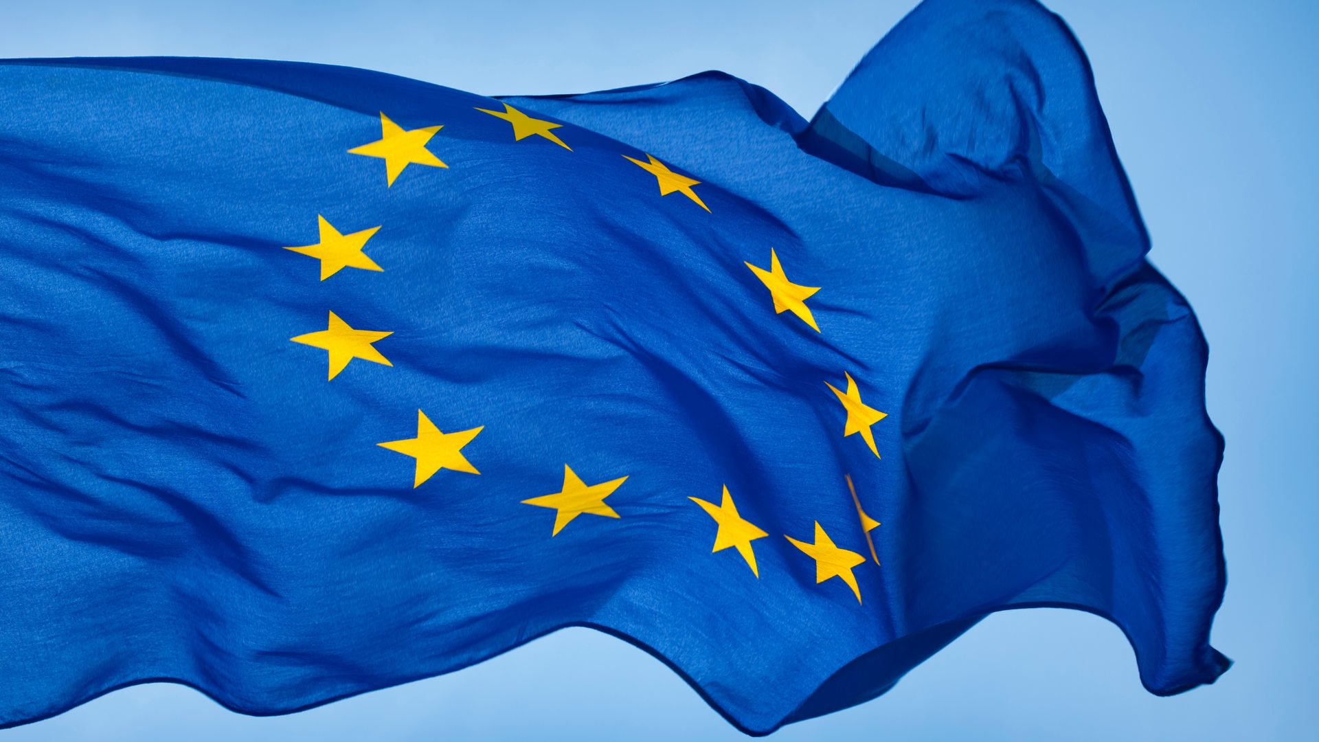 A large European Union flag waving in the wind.