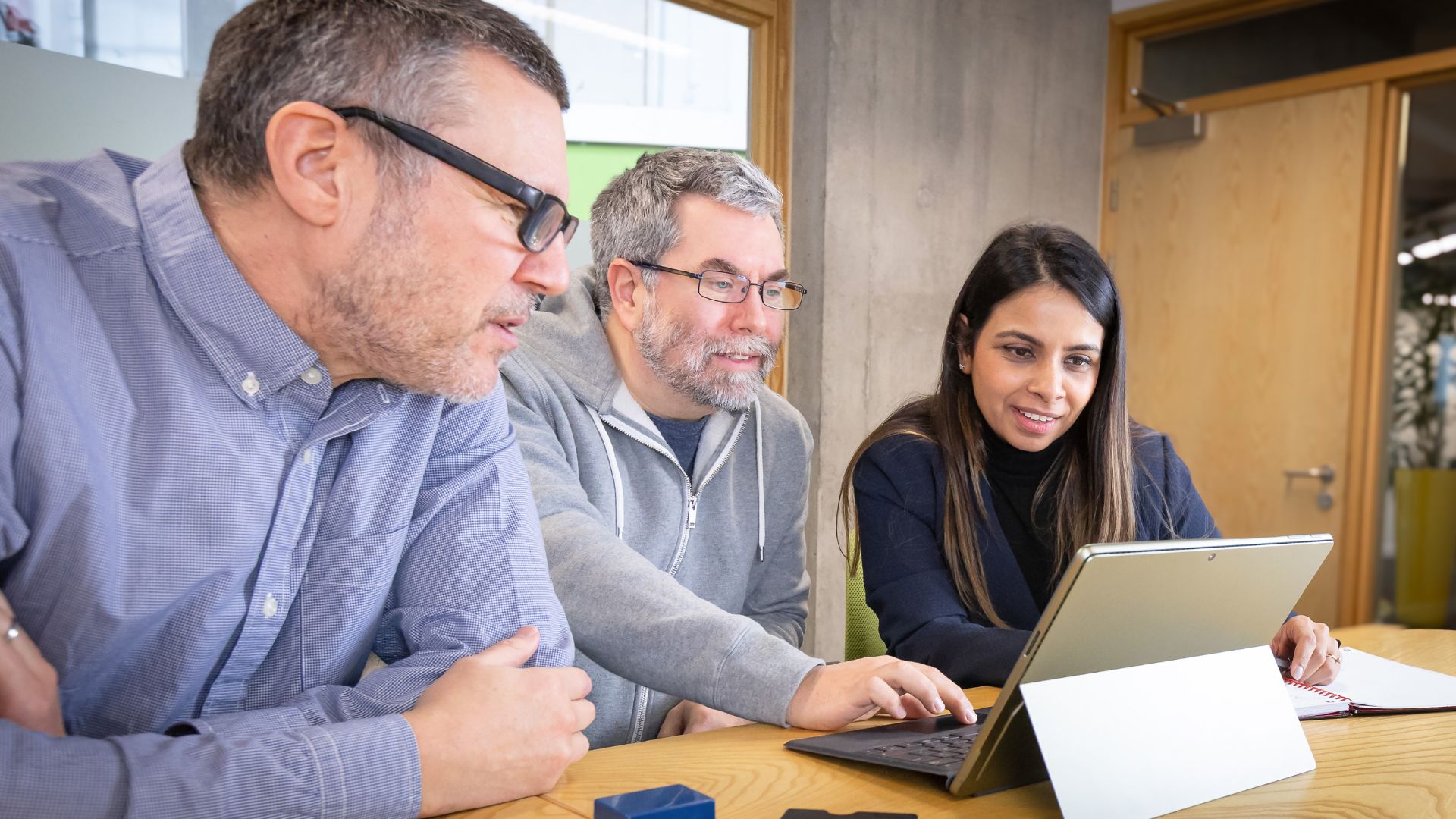 The Sensize team gathered around a desk analysing data.